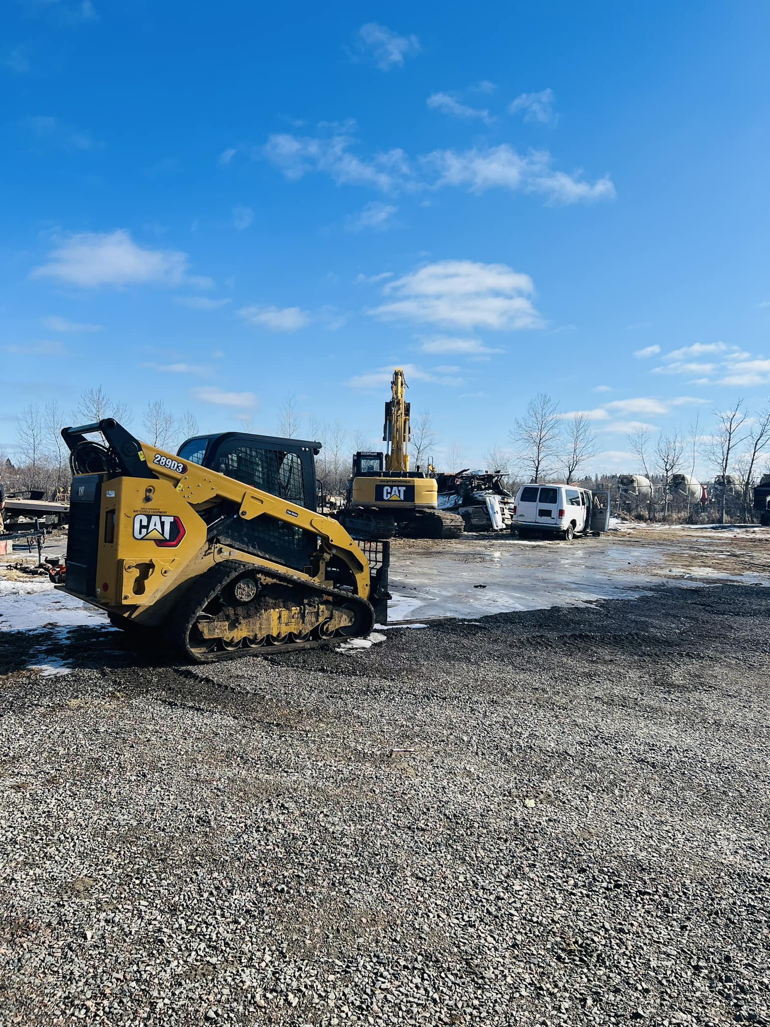 CAT skid steer and heavy equipment in the yard